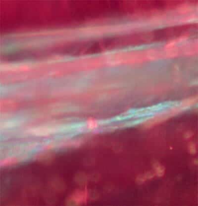 Glass-filled Composite Ruby - Blue and Orange flash effect along structural fractures