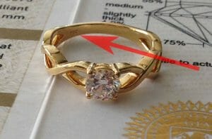 Best deal for diamond ring - Check metal quality stamp like this image where red arrow is pointing to '750' stamp which means 18K yellow gold
