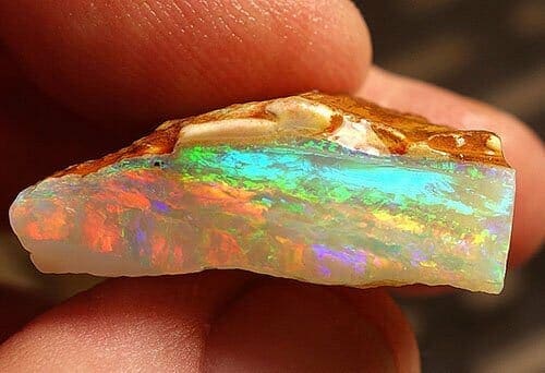 phenomena gemstones - side profile of rough opal crystal showing play-of-color